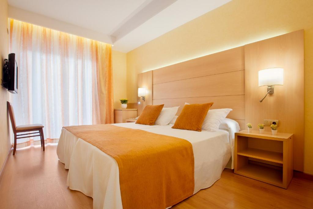 a hotel room with a large bed and a window at Hotel Pimar & Spa in Blanes