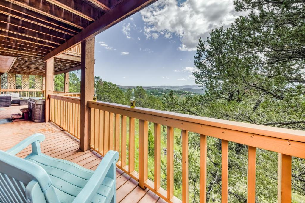 a deck with two blue chairs and a view at Living the Dream, 3 Bedrooms, Hot Tub, Fireplace, Sleeps 6 in Ruidoso