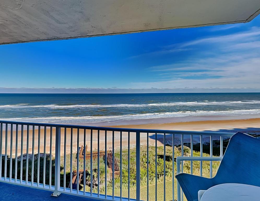 a view of the beach from a balcony at Sea Winds 602 in Ormond Beach