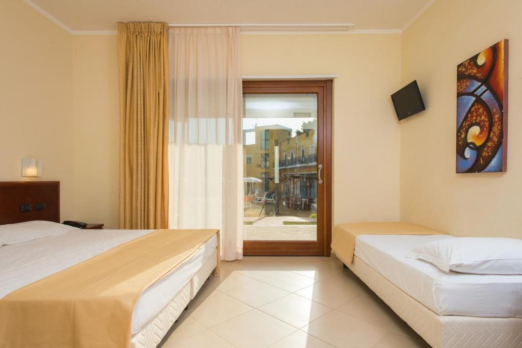 A bed or beds in a room at Hotel Orchidea Blu