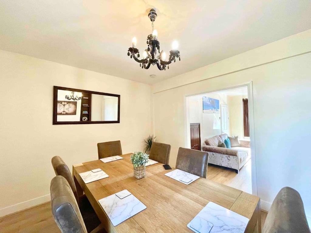 a dining room with a table and chairs and a couch at The Lancaster - relax and enjoy home near City Center with parking in Canterbury