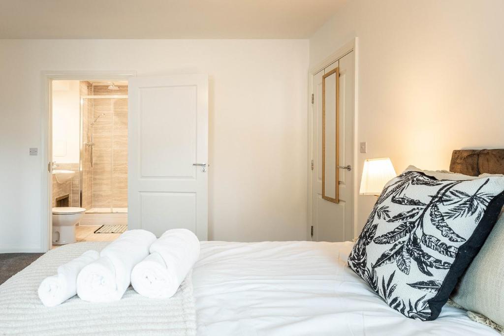 a bedroom with a bed with white towels on it at Comfy 2-Bed Flat in Dartford, Kent. in Kent