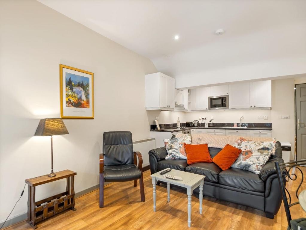 a living room with a couch and a chair at Town centre apartment, Clifden in Clifden