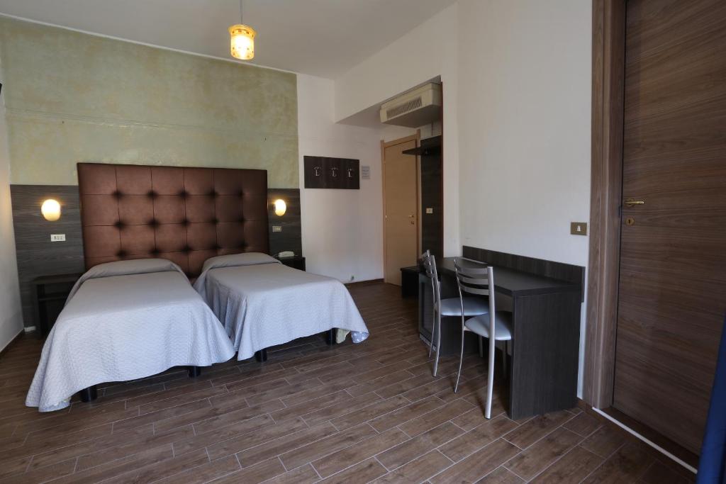 Postel nebo postele na pokoji v ubytování Hotel Piola