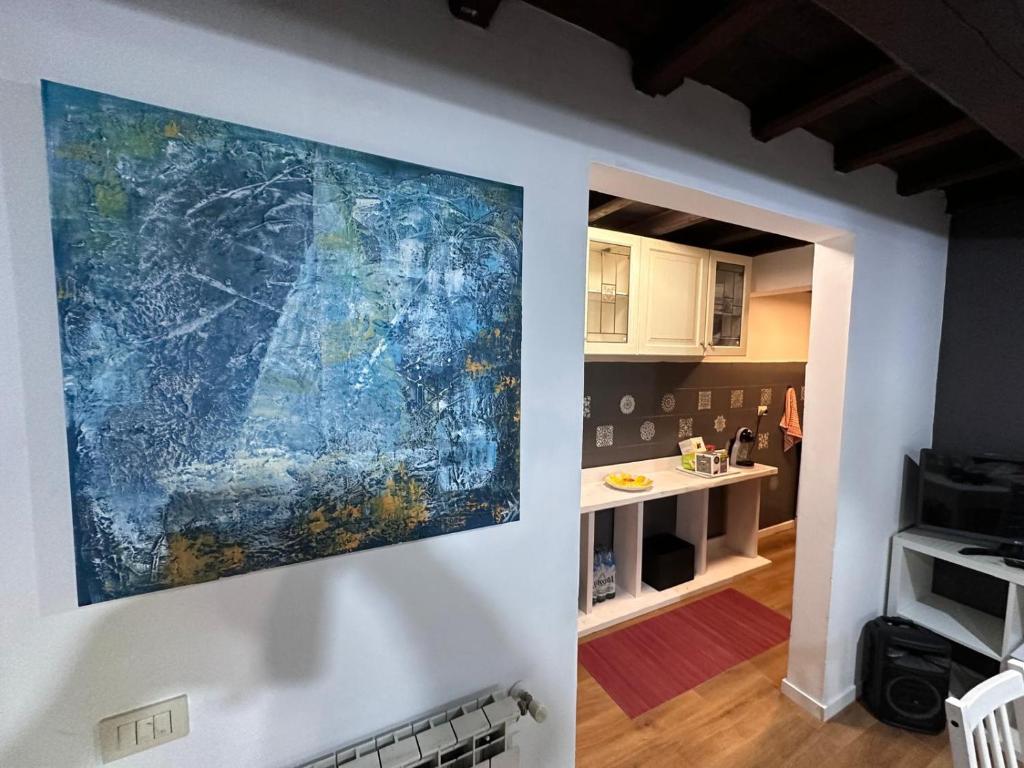 a painting hanging on a wall in a kitchen at Old Farm in Ostia Antica