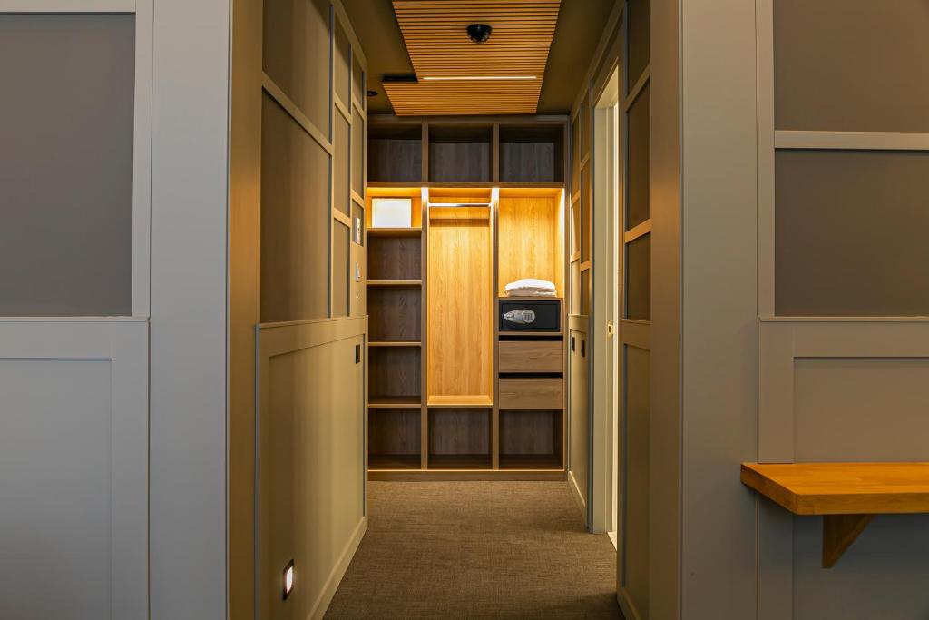 a hallway with a closet with wooden shelves at Hotel La Pau in Barcelona