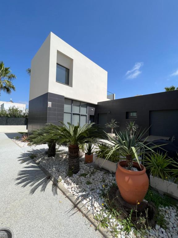 a house with plants in front of it at Luxury corner villa 3BR COSTA BLANCA in Alicante