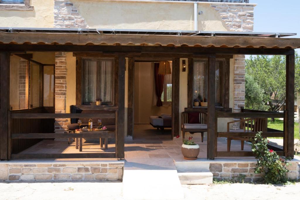 a screened in porch of a house with a table at K Bozcaada Revma in Bozcaada