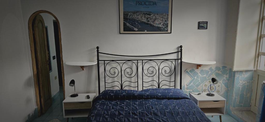 a bedroom with a blue bed and two night stands at Piccolo Tirreno Hotel Residence in Procida