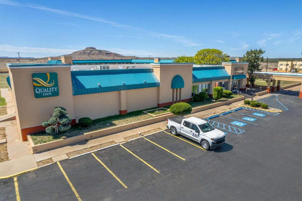 an aerial view of a hotel with a truck parked in a parking lot at Quality Inn in Tucumcari