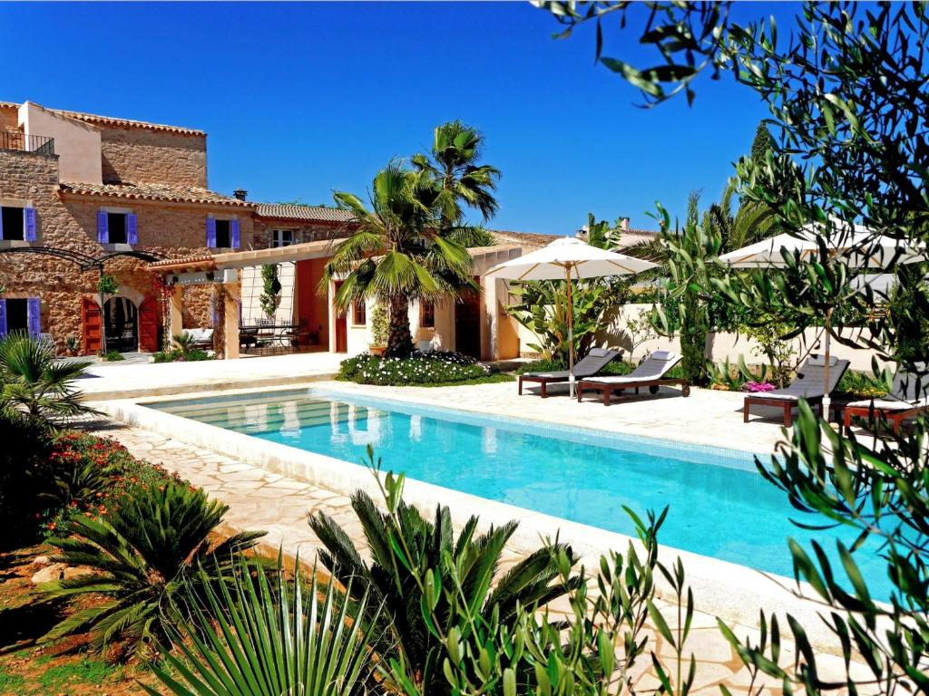 an exterior view of a house with a swimming pool at Casa 3 Leones in Llombarts