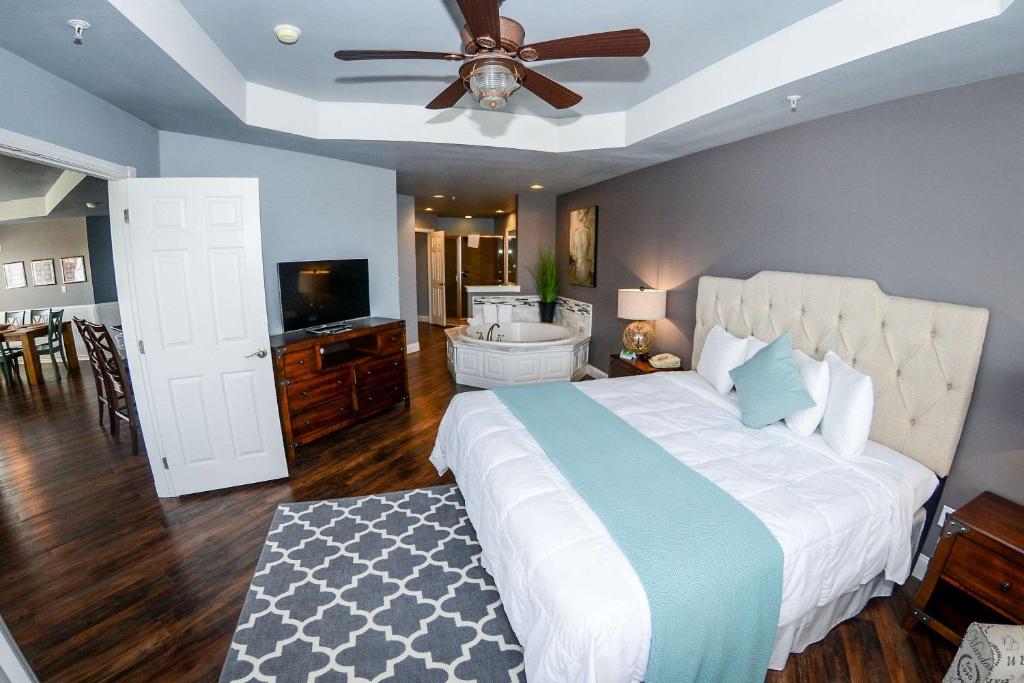 a bedroom with a large bed with a ceiling fan at Tanglewood Resort, Ascend Hotel Collection in Pottsboro