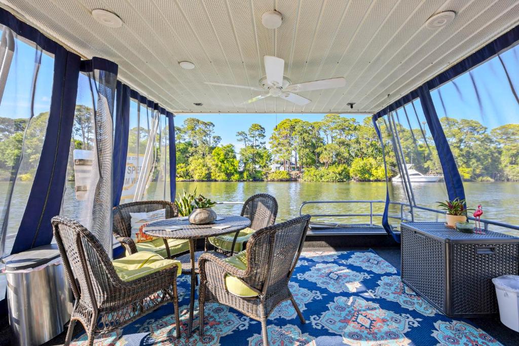 a room with chairs and a table on a boat at Pura Vida - Cape Crossing Resort and Marina in Merritt Island