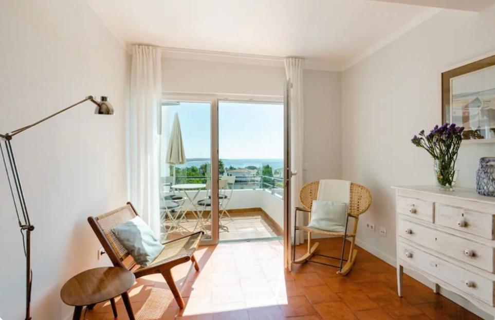 a living room with a chair and a dresser at Algarve dream seaview apartment w/pool near beach in Porches