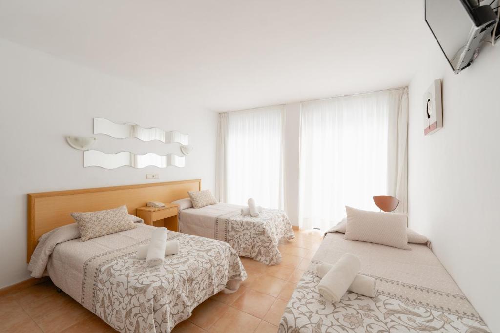 a bedroom with two beds and a window at Hotel Santa Faz TRG in Benidorm