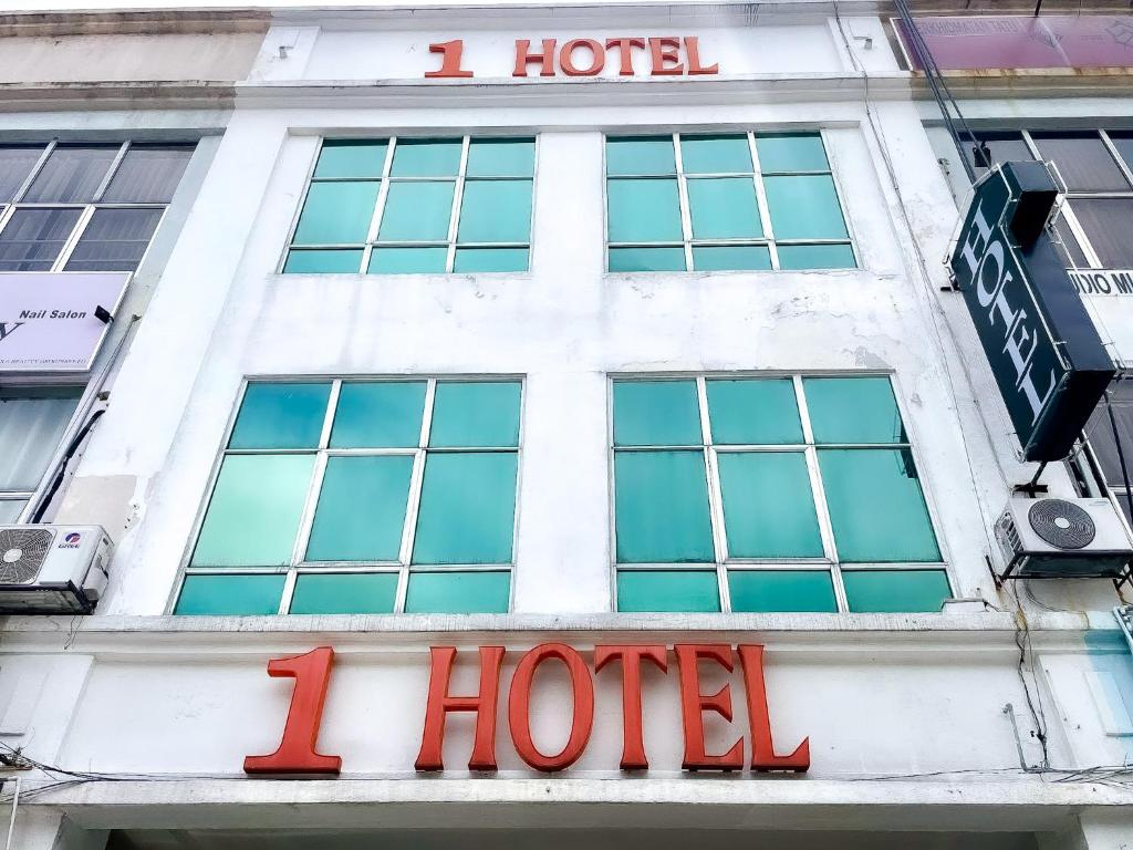 a white building with a hotel sign on it at 1 Hotel Taman Connaught in Kuala Lumpur