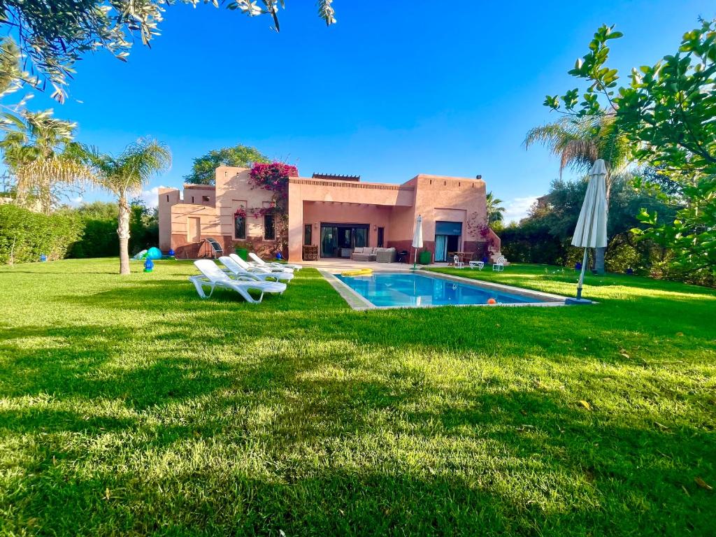 a house with a swimming pool in the yard at Entire villa with private pool in Marrakech in Marrakesh