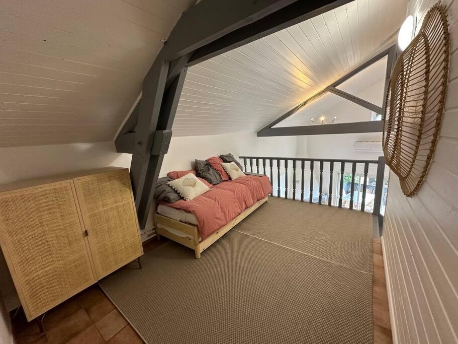 a room with a bed in the middle of a room at Magnifique mas provençal avec piscine au centre de Goudargues in Goudargues