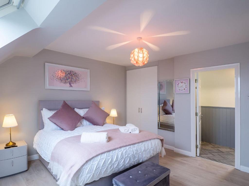 a bedroom with a bed and a ceiling fan at E2 Station House in Clifden