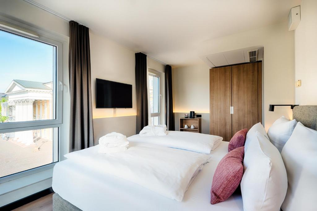 Postel nebo postele na pokoji v ubytování Welcome Hotel Darmstadt City Center