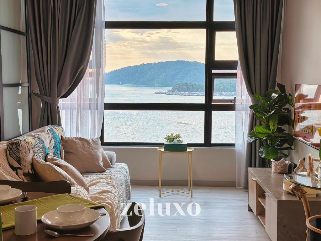 - un salon avec un canapé et une grande fenêtre dans l'établissement #1 Jesselton Quay City Pads Seaview by Zeluxo, à Kota Kinabalu