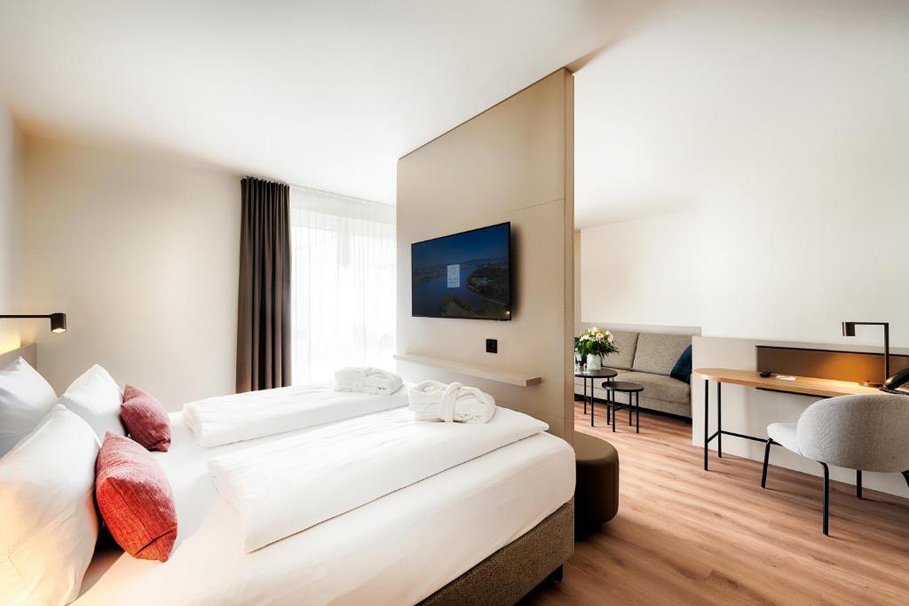 Postel nebo postele na pokoji v ubytování Welcome Hotel Darmstadt City Center