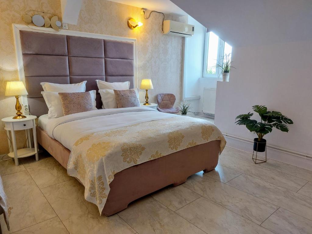 a bedroom with a large bed with a large headboard at Pension Casablanca in Campina