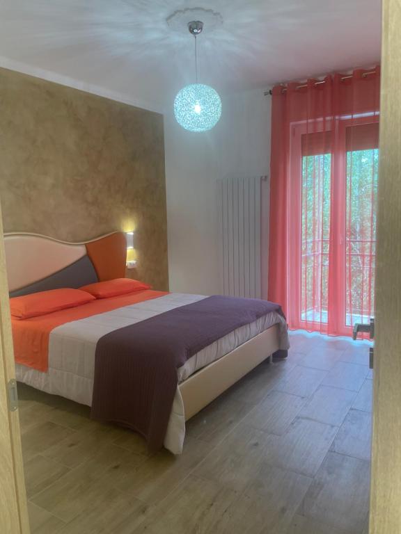 a bedroom with a bed and a large window at B&B Aeroporto in Azzano San Paolo