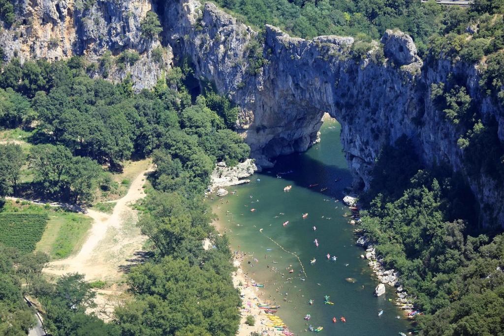 an aerial view of a river with a bridge at Mobile home 6 places camping 5 Vacances Gorges de lArdeche in Lagorce