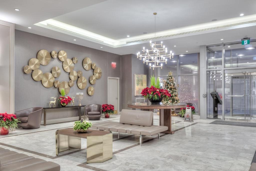 a lobby with a chandelier and a living room at Premier INN in Toronto