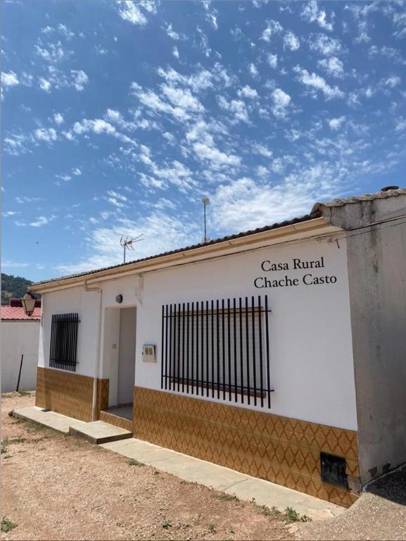 a white building with a sign on the side of it at Casa Rural Chache CASTO in Bienservida