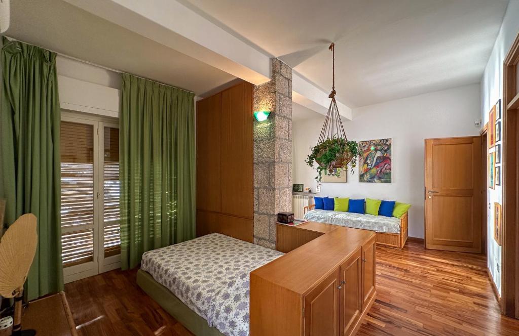 a bedroom with two beds and a desk in it at Villa Le Cale in Monte Argentario