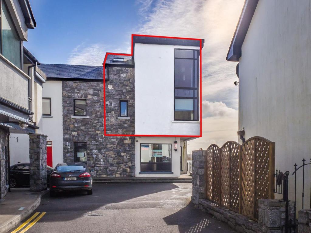 a building with a large window on the side of it at Carraroe Apartment in Carraroe