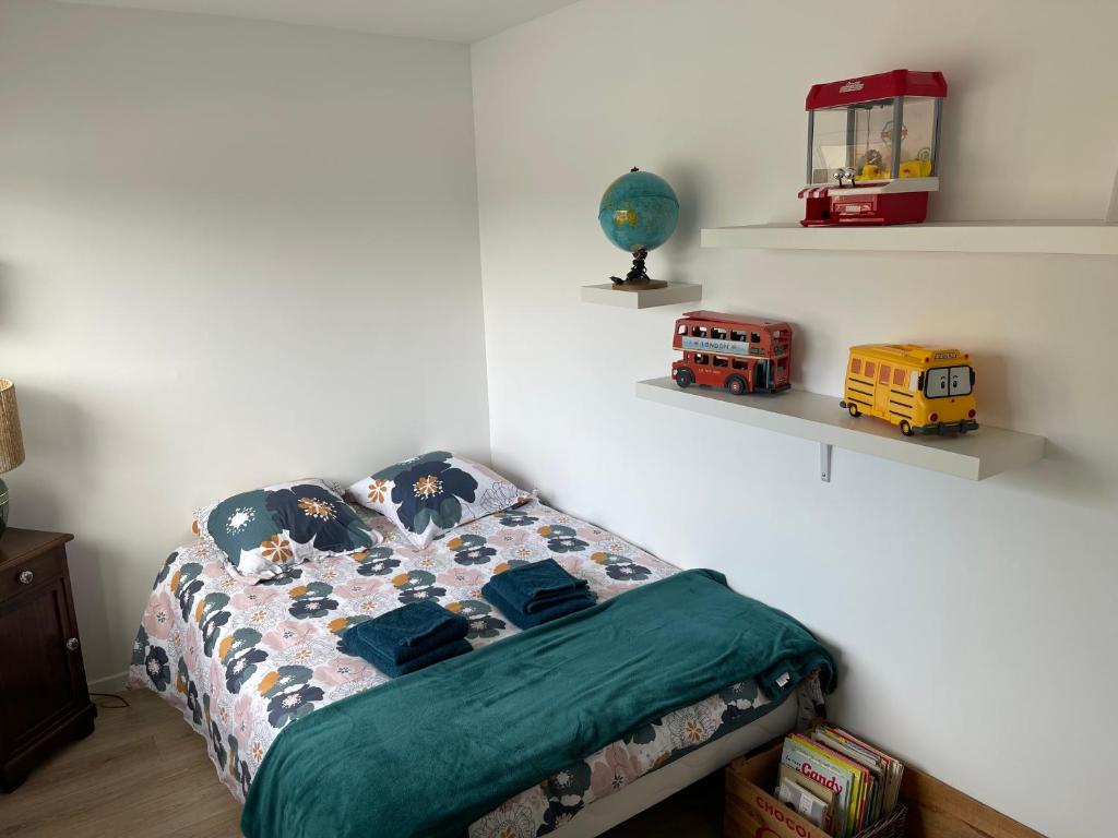 a bedroom with a bed with a toy bus on it at Rapas in Erdeven