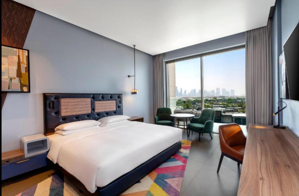een slaapkamer met een bed en een woonkamer bij Hyatt Centric Jumeirah - King Room Skyline - UAE in Dubai