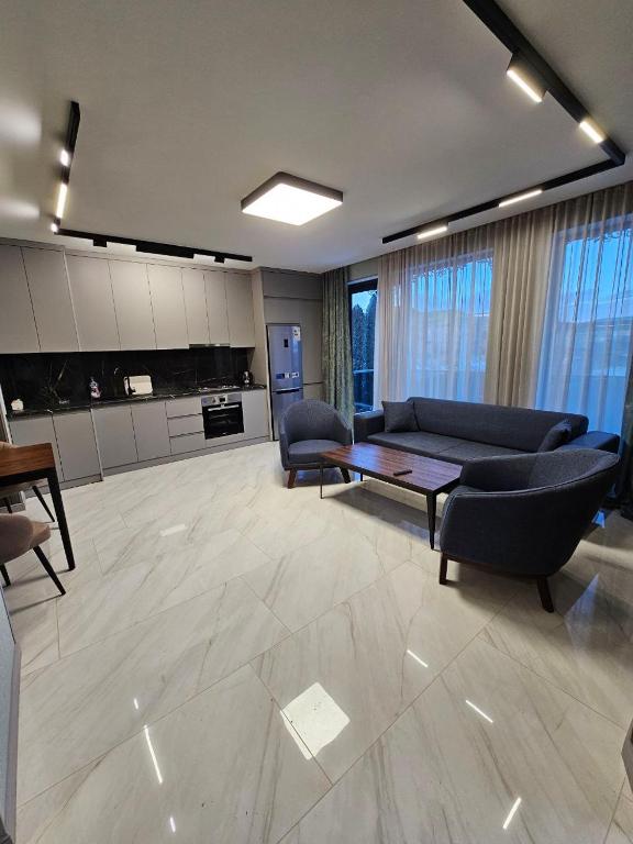 a large living room with a couch and a table at Centre Apartment in Gyumri