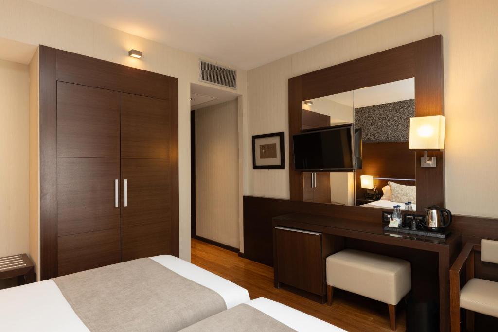 Postel nebo postele na pokoji v ubytování Barcelona Hotel Colonial