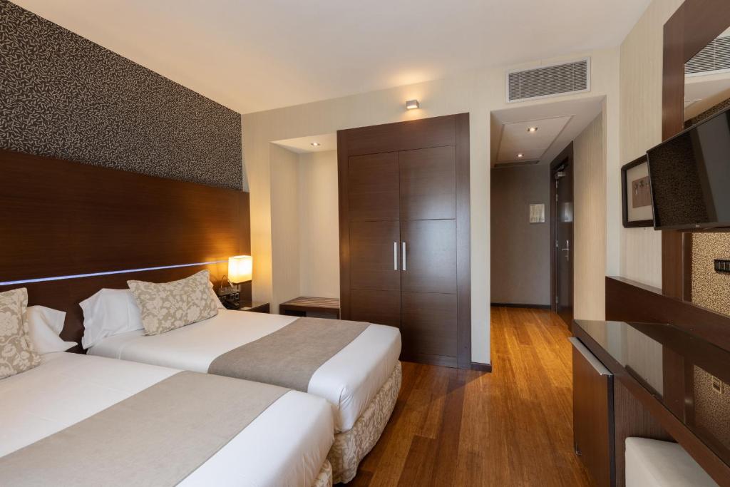 Postel nebo postele na pokoji v ubytování Barcelona Hotel Colonial