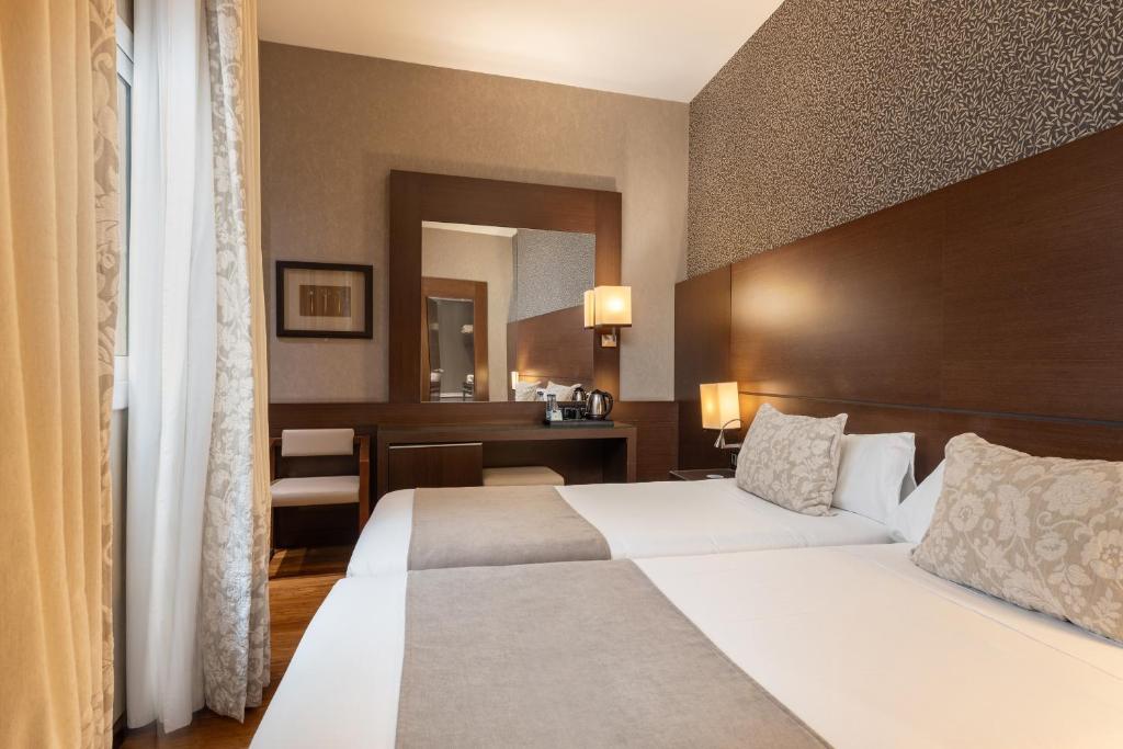 Postel nebo postele na pokoji v ubytování Barcelona Hotel Colonial