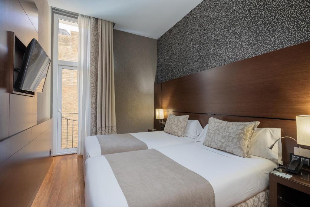 Postel nebo postele na pokoji v ubytování Barcelona Hotel Colonial