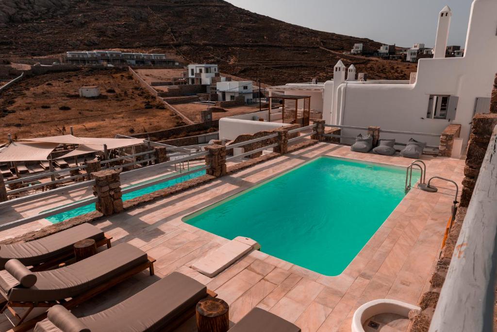 an image of a swimming pool with chaise lounge chairs at Senses Luxury Suites & Villas in Elia Beach