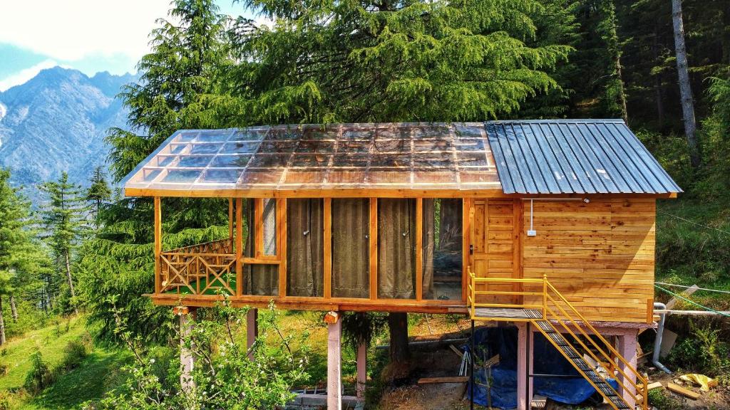 a house with a solar panel on top of it at Stargazing Treehouse Himachal in Sainj