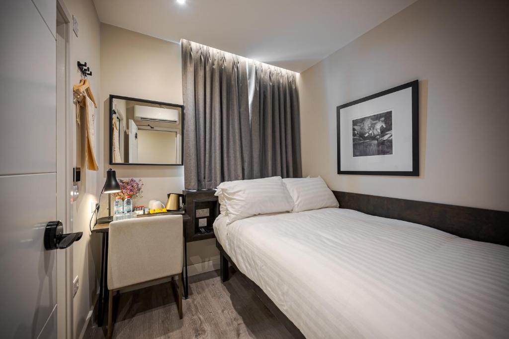 Postel nebo postele na pokoji v ubytování King's Cross Express Inn
