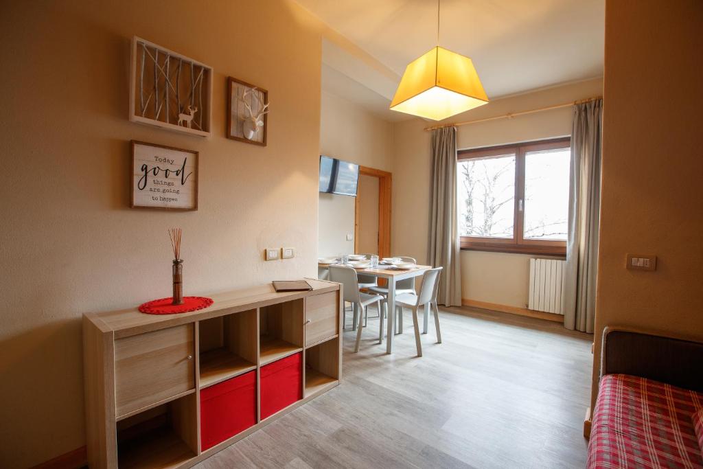 ボルミオにあるLa Villa Feleitのテーブルとダイニングルームが備わる小さな客室です。