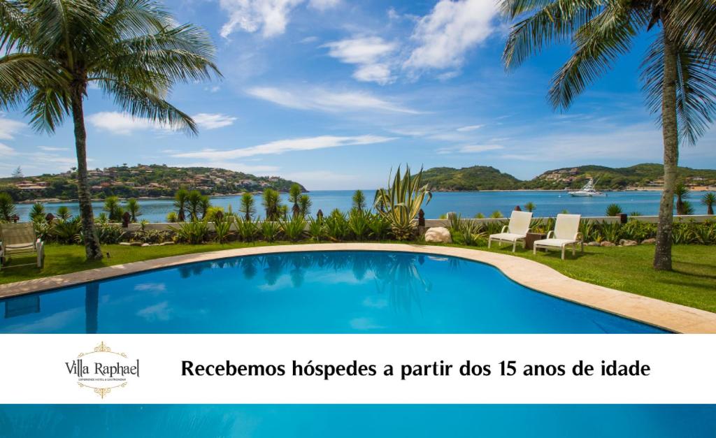 a swimming pool with a view of the ocean at Villa Raphael in Búzios