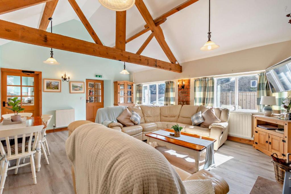 a living room with a couch and a table at Starling cottage w pool in North York Moors in Pickering