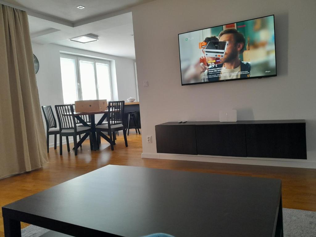 a living room with a flat screen tv on a wall at Apartmán centrum Bytča. in Bytča
