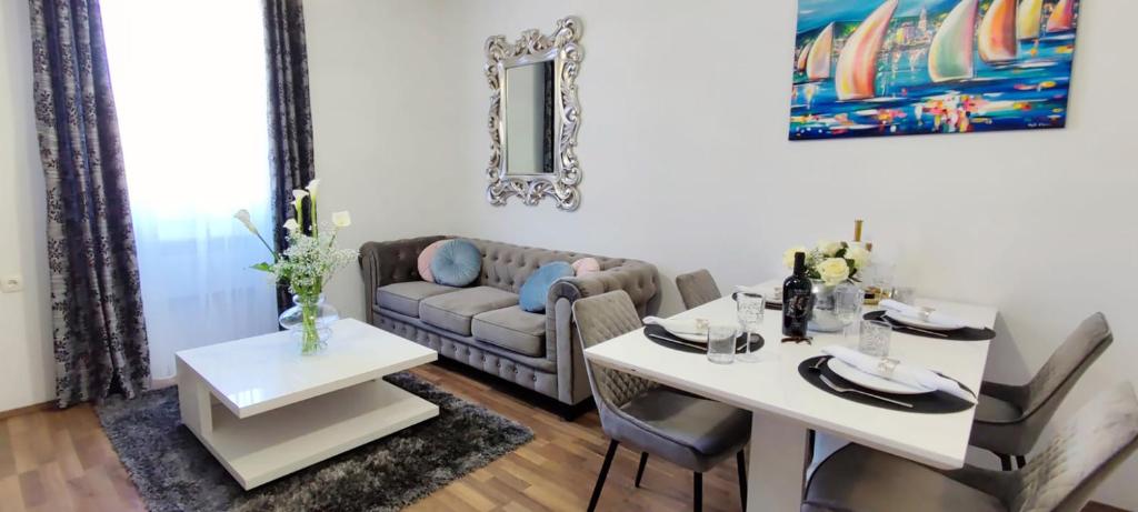 a living room with a table and a couch at Donat & Zara Apartment in Zadar