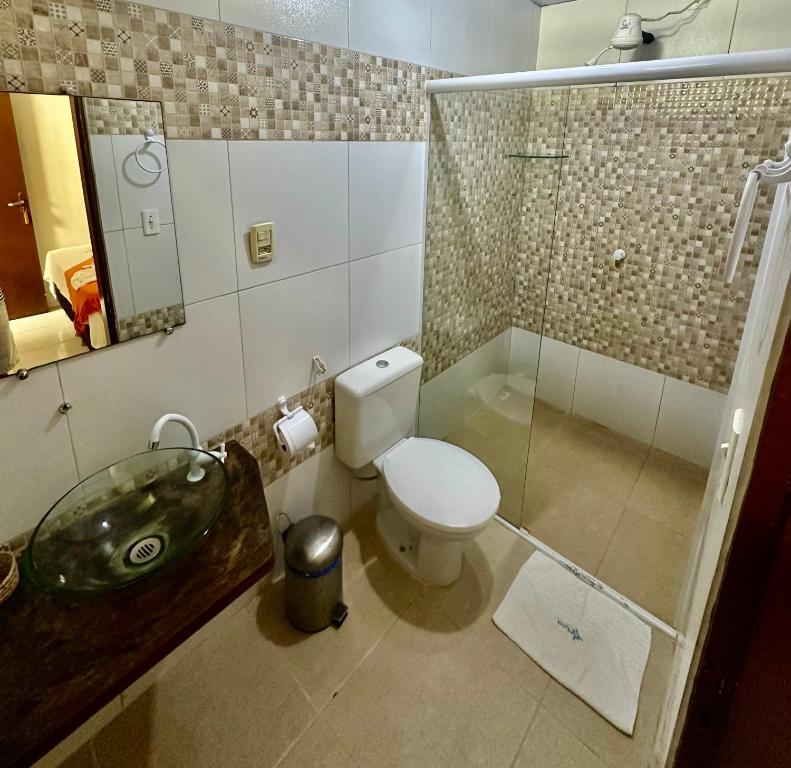 a bathroom with a toilet and a sink and a shower at Pousada Meu Xodó in Jericoacoara