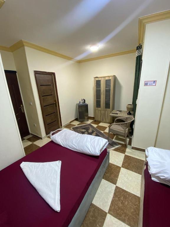 a bedroom with a purple bed in a room at Explore Stars Pyramids View in Cairo